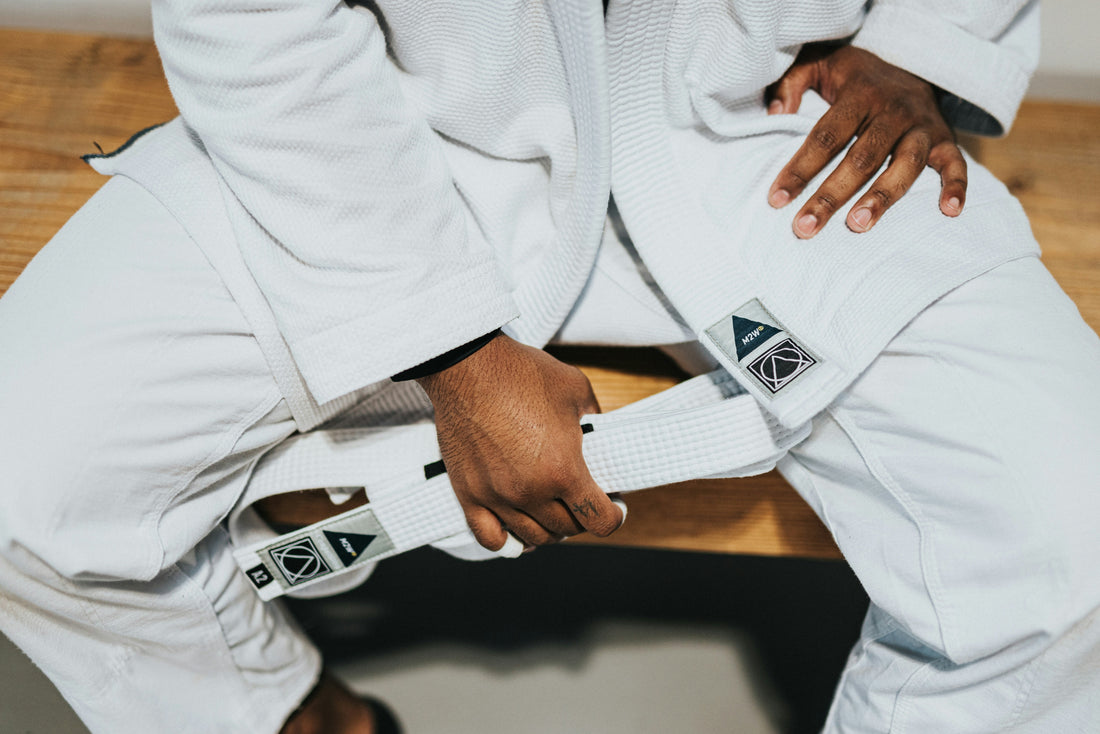 Tying white belt with proper technique White Belt and Gi BJJ outfit 